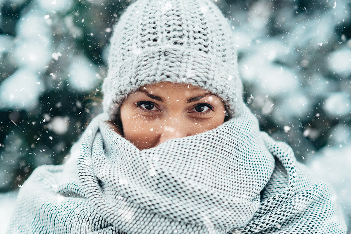 Beautiful young woman wearing scarf and a a hat on a cold winter day Beautiful young woman wearing scarf and a a hat on a cold winter day